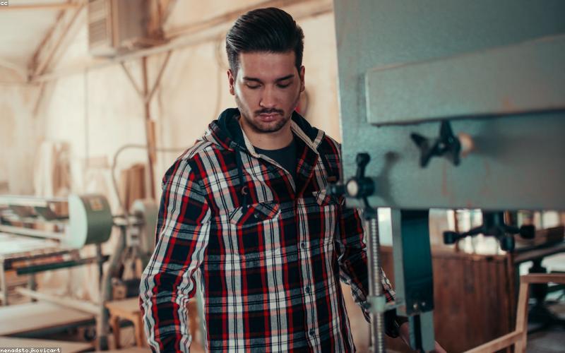 Woodworker crafting reclaimed wood shelf